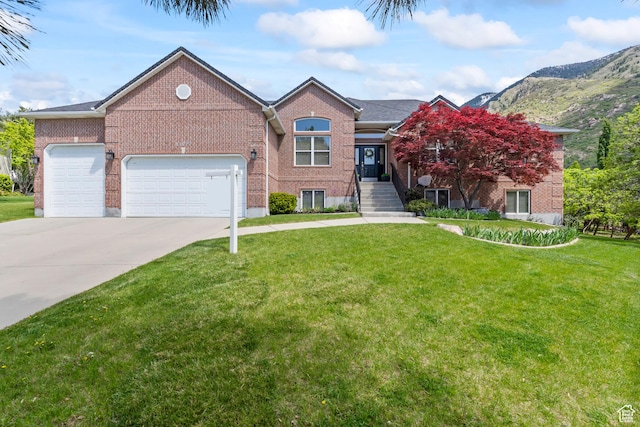 view of front facade with driveway, an attached garage, a front lawn, and brick siding