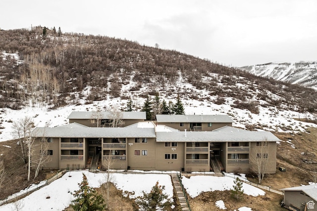 snowy aerial view featuring a mountain view