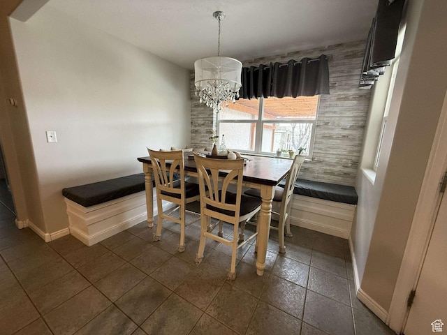dining room featuring baseboards and a notable chandelier