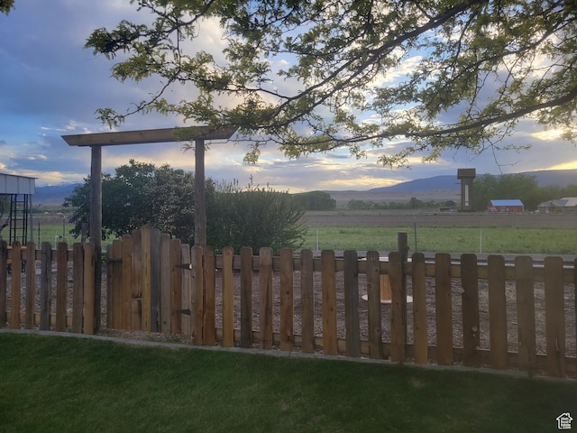 view of yard with a mountain view and fence