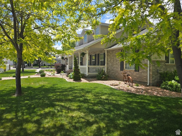432 S 575 W, Monroe, UT 84754 - view of side of home featuring covered porch, a lawn, and brick siding