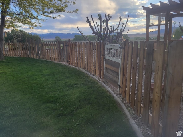 view of yard with a mountain view and fence