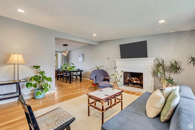 1055 E Chevy Chase Dr S, Murray, UT 84117 - living room with a lit fireplace, wood finished floors, and recessed lighting