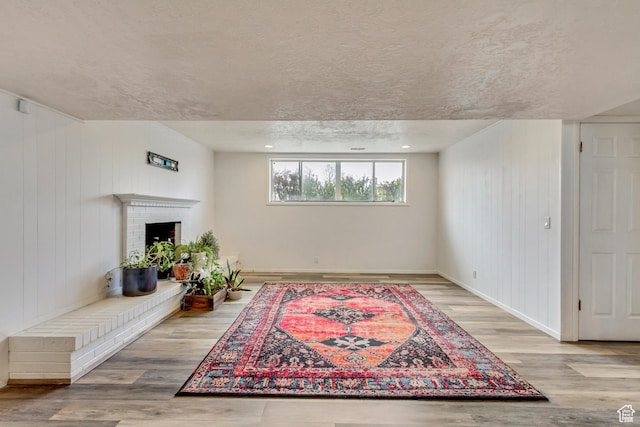 1055 E Chevy Chase Dr S, Murray, UT 84117 - sitting room with a textured ceiling, baseboards, a fireplace, and wood finished floors