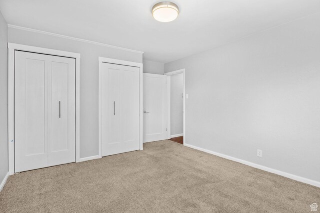 2928 S 575 W, Bountiful, UT 84010 - unfurnished bedroom with carpet floors, baseboards, and two closets