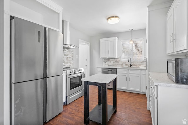 2928 S 575 W, Bountiful, UT 84010 - kitchen with wall chimney exhaust hood, stainless steel appliances, white cabinets, a sink, and backsplash