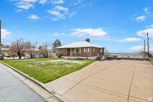 2928 S 575 W, Bountiful, UT 84010 - view of front of home featuring brick siding, a front lawn, and a chimney