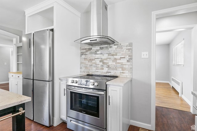 2928 S 575 W, Bountiful, UT 84010 - kitchen with wall chimney range hood, stainless steel appliances, backsplash, baseboards, and white cabinetry
