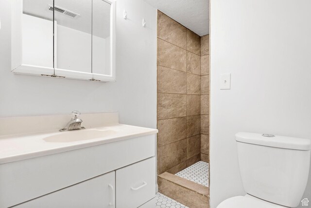 2928 S 575 W, Bountiful, UT 84010 - bathroom featuring visible vents, vanity, a tile shower, and toilet