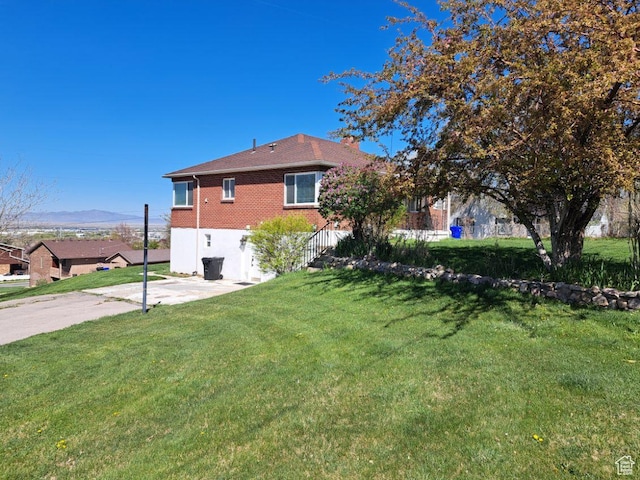 2928 S 575 W, Bountiful, UT 84010 - exterior space with brick siding, a mountain view, and a yard