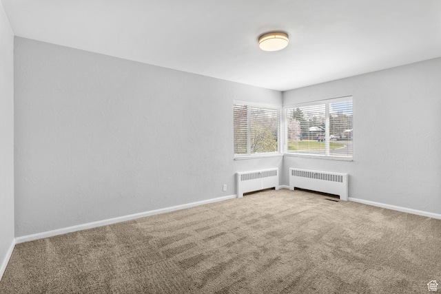 2928 S 575 W, Bountiful, UT 84010 - spare room with baseboards, radiator heating unit, and carpet flooring
