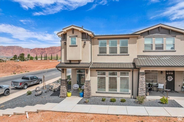 687 S Guy Ln Unit 1, Ivins, UT 84738 - view of front of house with stucco siding, stone siding, and a mountain view