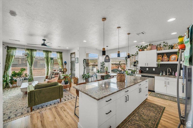 687 S Guy Ln Unit 1, Ivins, UT 84738 - kitchen featuring ceiling fan, open shelves, stainless steel dishwasher, and light wood-type flooring