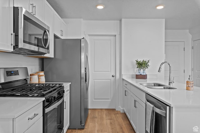 1596 S 3740 E Unit 1358, Spanish Fork, UT 84660 - kitchen featuring appliances with stainless steel finishes, a sink, light countertops, white cabinetry, and recessed lighting