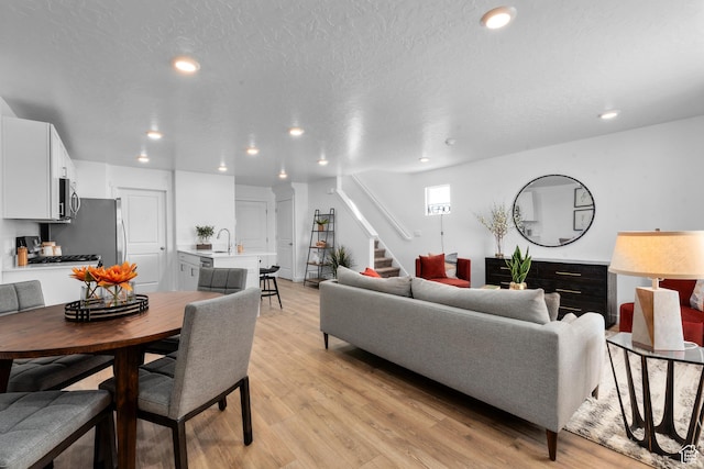 1596 S 3740 E Unit 1358, Spanish Fork, UT 84660 - living area featuring stairway, recessed lighting, and light wood-style flooring