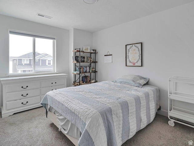 carpeted bedroom with visible vents