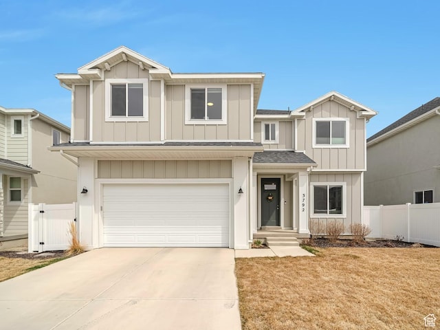 view of front of house with a garage, fence, board and batten siding, and concrete driveway
