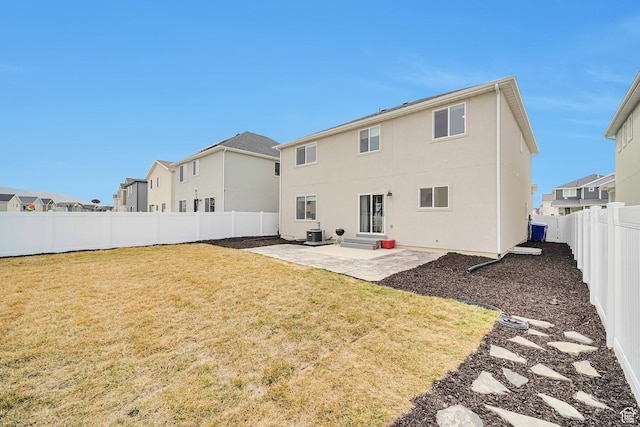 back of house with central AC unit, a patio, a fenced backyard, stucco siding, and a yard
