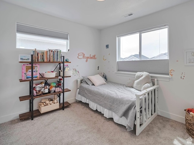 carpeted bedroom with baseboards and visible vents