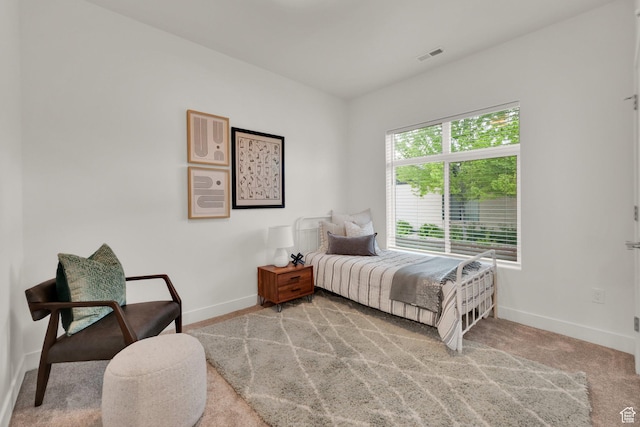 carpeted bedroom featuring baseboards