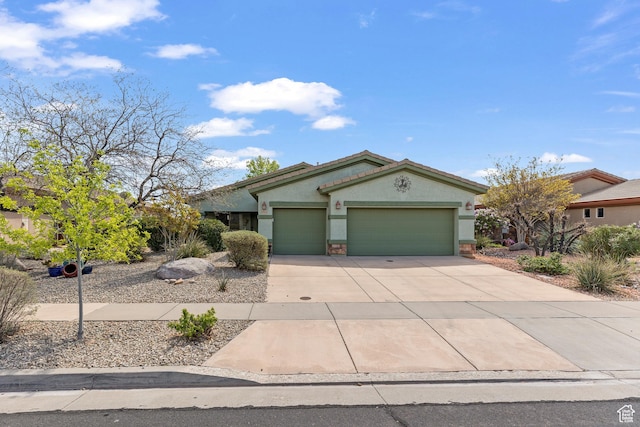 view of front of home with stucco siding, a garage, stone siding, and concrete driveway