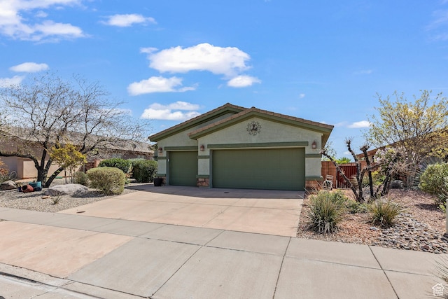 3352 E Sweetwater Springs Dr, Washington, UT 84780 - view of front of house with a garage, driveway, stucco siding, and fence