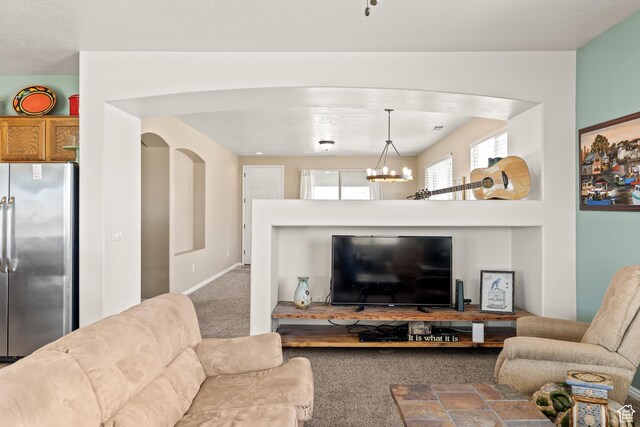 3352 E Sweetwater Springs Dr, Washington, UT 84780 - carpeted living area featuring arched walkways and a chandelier