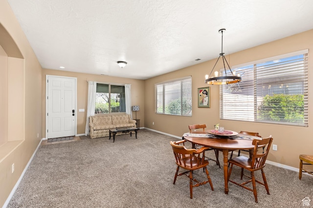 3352 E Sweetwater Springs Dr, Washington, UT 84780 - carpeted dining space with baseboards, a textured ceiling, and an inviting chandelier