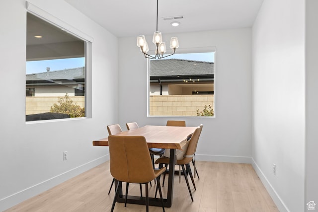 698 W Cypress Umber Dr, St George, UT 84790 - dining room featuring visible vents, an inviting chandelier, wood finished floors, and a healthy amount of sunlight