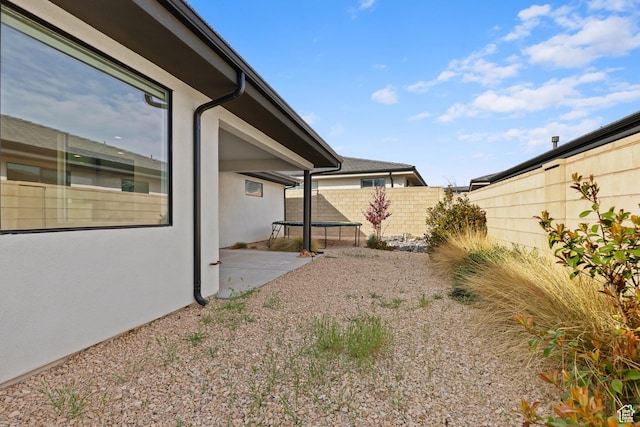 698 W Cypress Umber Dr, St George, UT 84790 - view of yard featuring a fenced backyard, a patio area, and a trampoline