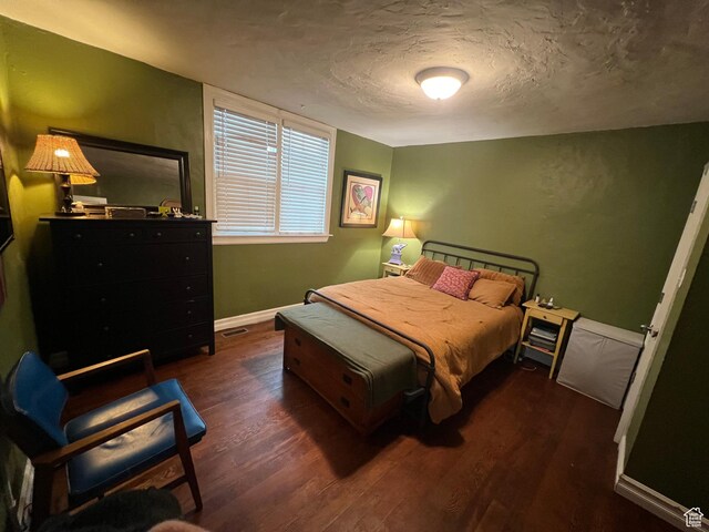 151 S Windsor St E, Salt Lake City, UT 84102 - bedroom with visible vents, dark wood-style floors, baseboards, and a textured ceiling