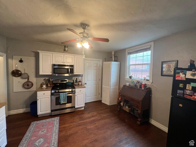 151 S Windsor St E, Salt Lake City, UT 84102 - kitchen featuring white cabinets, baseboards, ceiling fan, stainless steel appliances, and dark wood-type flooring