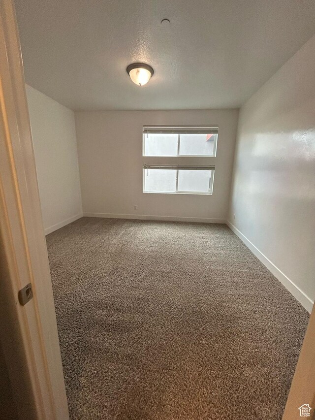 875 S Depot St E Unit C307, Clearfield, UT 84015 - spare room with baseboards, carpet flooring, and a textured ceiling