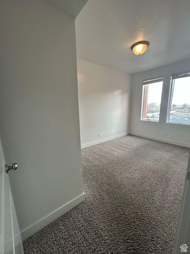 875 S Depot St E Unit C307, Clearfield, UT 84015 - spare room with baseboards, carpet floors, and a textured ceiling