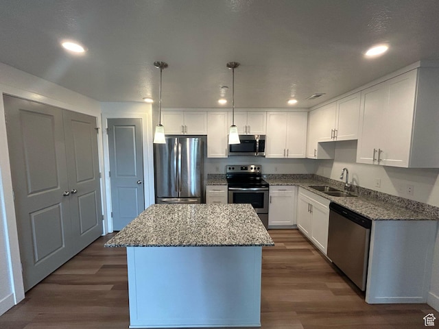 875 S Depot St E Unit C307, Clearfield, UT 84015 - kitchen with a kitchen island, a sink, appliances with stainless steel finishes, and dark wood finished floors