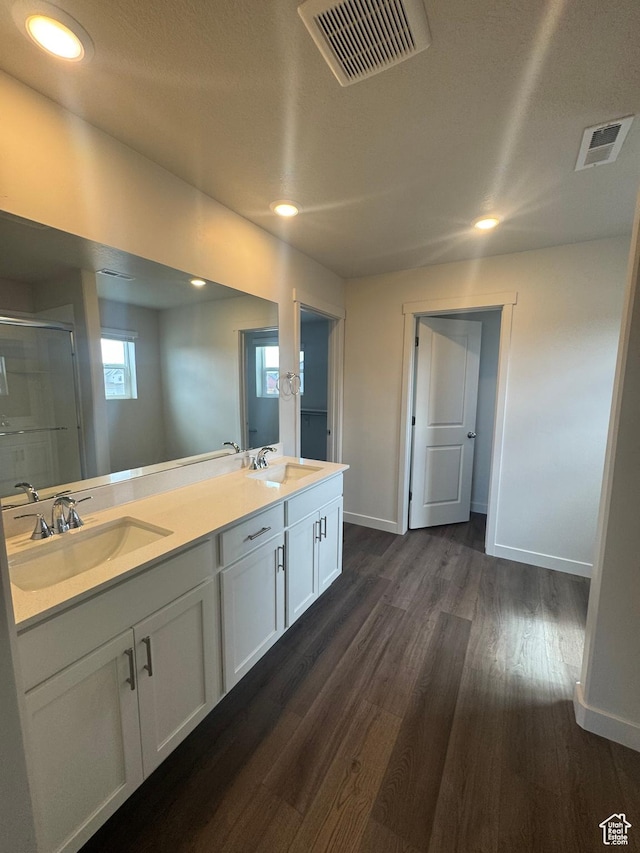 1355 N Harper Way Unit 249, Tooele, UT 84074 - full bathroom with double vanity, wood finished floors, a stall shower, and recessed lighting