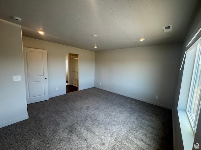 1355 N Harper Way Unit 249, Tooele, UT 84074 - unfurnished bedroom featuring dark colored carpet and recessed lighting