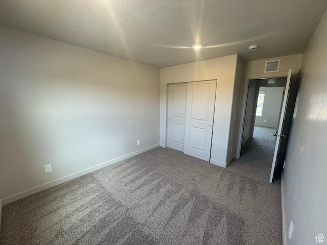 1355 N Harper Way Unit 249, Tooele, UT 84074 - unfurnished bedroom with carpet, a closet, and a textured ceiling