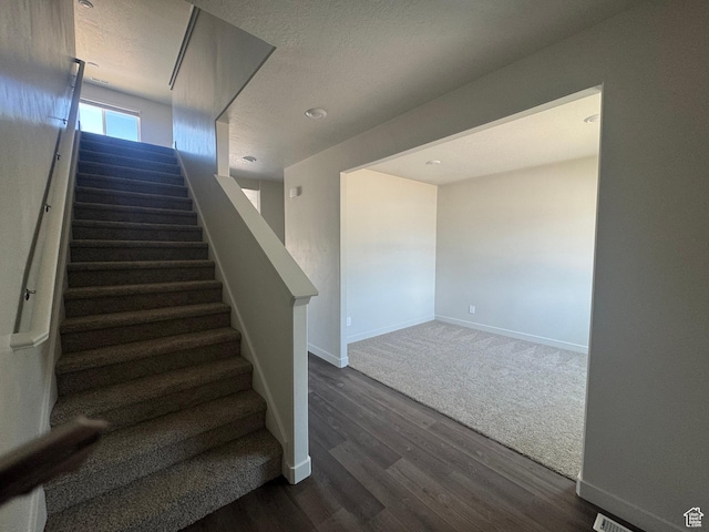 1355 N Harper Way Unit 249, Tooele, UT 84074 - staircase featuring wood finished floors and a textured ceiling
