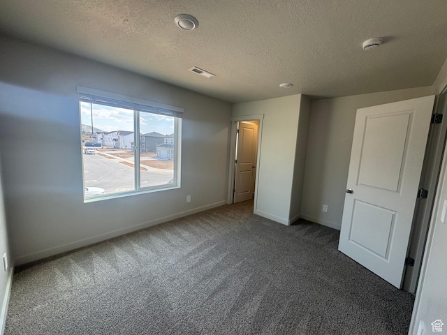 1355 N Harper Way Unit 249, Tooele, UT 84074 - unfurnished bedroom featuring carpet floors and a textured ceiling