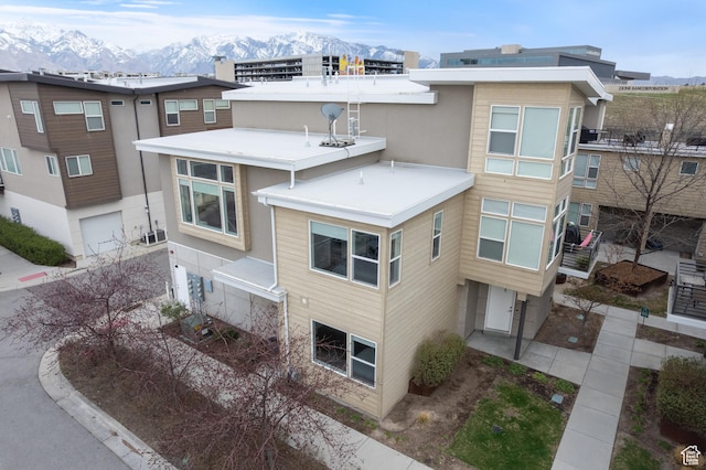 exterior space featuring an attached garage and a mountain view