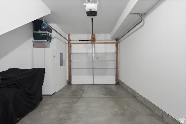 1051 W Rooftop Dr S Unit 401, Midvale, UT 84047 - garage with electric panel and a garage door opener