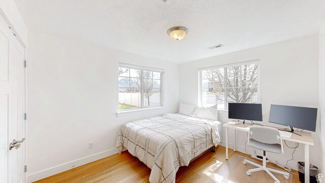 2527 W 500 S Unit 1, Springville, UT 84663 - bedroom featuring baseboards, visible vents, wood finished floors, and a textured ceiling
