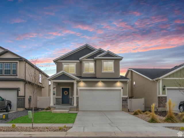 craftsman-style home featuring driveway, a gate, stucco siding, fence, and an attached garage