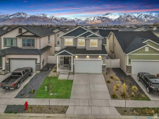 1710 S Prevedel Dr, West Haven, UT 84401 - traditional-style home featuring stucco siding, fence, an attached garage, driveway, and a mountain view