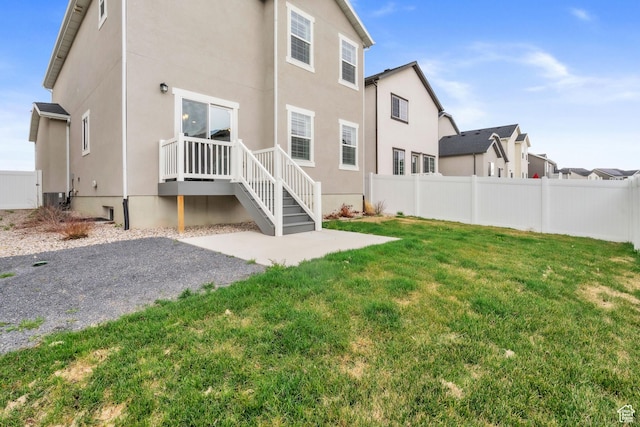 1710 S Prevedel Dr, West Haven, UT 84401 - back of house featuring a yard, stucco siding, and fence