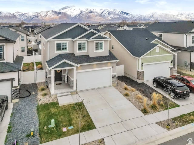 1710 S Prevedel Dr, West Haven, UT 84401 - view of front of property featuring concrete driveway, stucco siding, fence, a residential view, and a mountain view