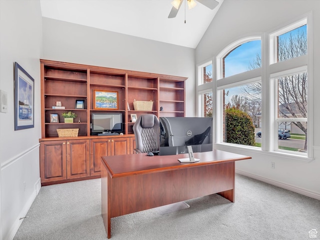office space with a ceiling fan, baseboards, and light colored carpet