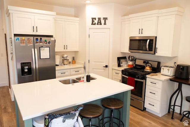 686 N 275 W Unit 1, La Verkin, UT 84745 - kitchen with a sink, stainless steel appliances, a breakfast bar area, and light wood-style floors