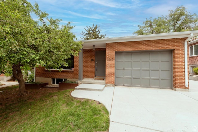 ranch-style home with concrete driveway, brick siding, and a garage